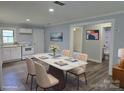 Bright dining room featuring a modern table with seating for four and an open view to the kitchen at 1150 Shue Rd, China Grove, NC 28023