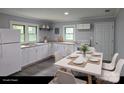 Functional kitchen area with white cabinets, modern appliances, and an adjacent dining space at 1150 Shue Rd, China Grove, NC 28023