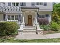Inviting front porch with stone steps, white columns, and a wooden door adorned with a decorative wreath at 1200 Rutledge Ave, Charlotte, NC 28211