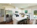Bright kitchen featuring white cabinets, stainless appliances, and a kitchen island with bar stool seating at 136 Parker Claire Ln, Kings Mountain, NC 28086