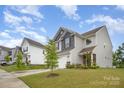 Well-manicured lawns and two-story homes create a welcoming neighborhood atmosphere on a beautiful sunny day at 18026 Stark Way, Charlotte, NC 28278