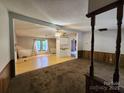 Inviting living room featuring an open layout with hardwood and carpeted floors, seamlessly connecting to the kitchen at 269 Saddle Rd, Lancaster, SC 29720