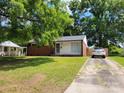 Charming single-story home with brick accents, a well-maintained lawn, and a private driveway at 2939 Lasalle St, Charlotte, NC 28216