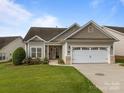 Charming single-Gathering home with a two-car garage, lush lawn, and welcoming curb appeal on a sunny day at 301 Garner Dr, Salisbury, NC 28146