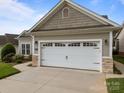 A close-up of the garage of a charming single-Gathering home with a two-car garage and stone accents at 301 Garner Dr, Salisbury, NC 28146