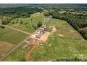 Drone view of multiple homes in the area with green fields and a street going through them at 355 Northbrook Iii School Rd # 10, Vale, NC 28164