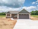 Beautiful exterior showcasing a beige house, brown garage door, and inviting driveway at 355 Northbrook Iii School Rd # 10, Vale, NC 28164