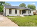 Charming brick home with a well-manicured lawn and inviting front porch exudes curb appeal at 3937 Tamerlane Dr, Charlotte, NC 28205
