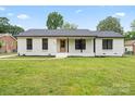 Charming brick home with a well-manicured lawn and inviting front porch exudes curb appeal at 3937 Tamerlane Dr, Charlotte, NC 28205