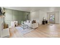 Bright living room with light hardwood floors, a decorative fireplace, and stylish furnishings at 3937 Tamerlane Dr, Charlotte, NC 28205