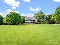 Expansive front yard showcasing a well-maintained lawn and mature trees surrounding the home at 4628 Dovefield Ln, Kannapolis, NC 28081