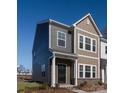 Stylish townhome showcases neutral siding, trimmed windows, and a welcoming, covered entrance at 5203 Shasta St # 5203, Gastonia, NC 28052