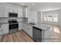 Modern kitchen featuring white cabinets, stainless steel appliances, and granite countertops at 5203 Shasta St # 5203, Gastonia, NC 28052