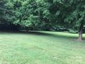 Spacious front yard offers plenty of room with mature trees providing shade, enhancing the beauty of the property at 609 E Church St, China Grove, NC 28023