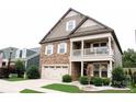 Inviting exterior with stone accents, covered porch, two car garage, and well-maintained lawn at 745 Garrett Green Way, Fort Mill, SC 29715