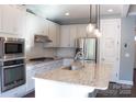 Modern kitchen featuring stainless steel appliances, marble backsplash, and a large kitchen island at 745 Garrett Green Way, Fort Mill, SC 29715