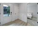 Bright entryway featuring wood-look flooring, a modern door, and access to a bedroom at 8723 Nolley Ct, Charlotte, NC 28270