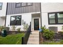 A close-up exterior showcases black framed entry door, landscaping, and modern design elements at 8723 Nolley Ct, Charlotte, NC 28270