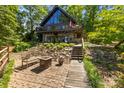 Charming home exterior featuring stone accents, a balcony, and inviting outdoor spaces at 9289 Azalea Rd, Sherrills Ford, NC 28673