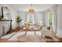 Cozy living room featuring a decorative fireplace, stylish decor, and bright, neutral colors at 1000 Oakshade Ave, Kannapolis, NC 28083