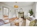Bright living room with a decorative fireplace, stylish decor, and an open doorway at 1000 Oakshade Ave, Kannapolis, NC 28083
