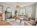 Bright living room with a decorative fireplace, stylish decor, and a tan sofa at 1000 Oakshade Ave, Kannapolis, NC 28083