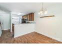 Bright dining area showcases wood flooring and a lovely light fixture, creating a welcoming atmosphere at 1215 Green Oaks Ln # H, Charlotte, NC 28205