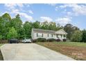 A serene home featuring a long driveway and lush green surroundings at 1221 Woodpecker Dr, Clover, SC 29710