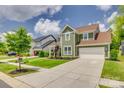Two-story home boasts lush landscaping, a welcoming front porch, and a long driveway at 155 Boxelder Rd, Clover, SC 29710