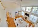 Aerial view of the living room with a fireplace and soaring ceilings and large windows at 1708 Aringill Ln, Matthews, NC 28104