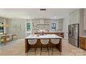 Open kitchen boasts a large island with seating, modern lighting, and stainless steel appliances at 1711 Summey Ave, Charlotte, NC 28205