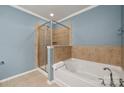 Relax in this bathroom with a separate shower and soaking tub with tiled walls at 17916 Ragtop Day Ln, Cornelius, NC 28031
