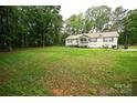 Spacious front yard showcases a charming home nestled among mature trees, offering a serene setting at 1821 Sherrer Rd, York, SC 29745