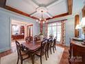 Formal dining room showcasing a chandelier, rich wood accents, and a view into the office at 200 Waterby Way, Matthews, NC 28104