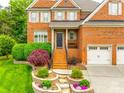 Charming brick home featuring a well-maintained front yard and attached two-car garage at 208 Mcduffie Ln, Fort Mill, SC 29715