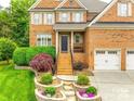 Charming brick two-story home with a well-manicured lawn and a two-car garage at 208 Mcduffie Ln, Fort Mill, SC 29715