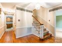 Inviting entryway with hardwood floors, a staircase, and decorative wall trim, creating a warm welcome at 2330 Raven Dr, Rock Hill, SC 29732