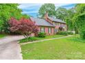 Charming brick home with a well-maintained lawn, complemented by a vibrant Japanese maple near the driveway at 2330 Raven Dr, Rock Hill, SC 29732