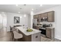 A modern kitchen showcases a kitchen island, stainless steel appliances, and granite countertops at 2922 Sloan Dr, Charlotte, NC 28208