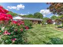 Well-maintained ranch home featuring a beautifully landscaped front yard and mature trees at 3008 Imperial Dr, Gastonia, NC 28054