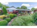 Well-maintained lawn and beautiful landscaping enhance this charming brick home's curb appeal at 3008 Imperial Dr, Gastonia, NC 28054