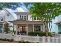 Lovely two-story home with a classic white exterior, covered porch, and well-manicured landscaping at 330 Horton Grove Rd, Fort Mill, SC 29715