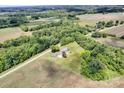 Aerial view showcasing the charming property bordered by verdant trees and sprawling farmland, a serene rural oasis at 335&315 Graham Rd, Mt Ulla, NC 28125