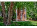Elegant brick home showcasing white pillars, a well-manicured lawn, and mature trees at 3617 Ruth St, Indian Trail, NC 28079