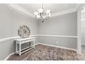 Formal dining room showcases updated light fixture, light gray paint, and elegant trimwork at 3820 Leela Palace Way, Fort Mill, SC 29708
