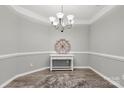 Formal dining room showcases updated light fixture, light gray paint, and elegant trimwork at 3820 Leela Palace Way, Fort Mill, SC 29708