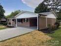 A single-story brick home with a convenient carport and well-maintained landscaping at 404 Kings Dr # 7, Cherryville, NC 28021