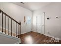 Inviting entryway with hardwood floors, decorative front door, and stairway at 446 Misty Law Ln, Clover, SC 29710
