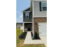 Stylish two-story home with a welcoming porch, brick accents, and manicured landscaping at 446 Misty Law Ln, Clover, SC 29710