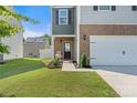 Charming home facade with a welcoming front door, rocking chair and well-kept lawn at 446 Misty Law Ln, Clover, SC 29710